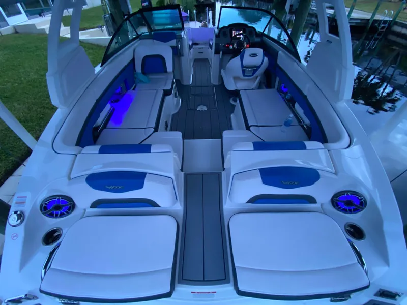 Slide: The Image of 2020 Chaparral 223 Vortex VRX boat interior with blue LED lighting and spacious seating. - 6