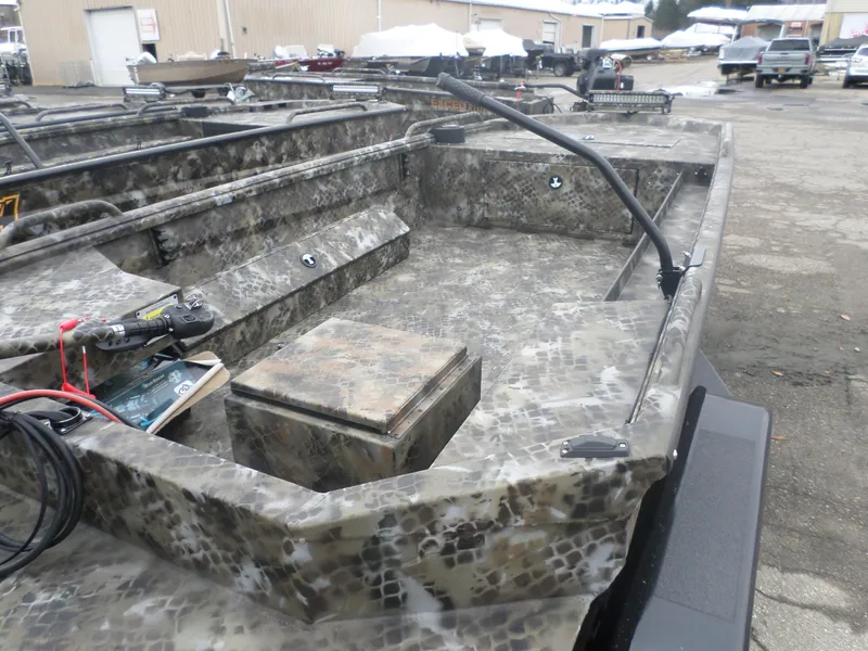 Slide: The Image of 2025 Excel 1860 Pro boat with camouflage design in a parking lot. - 3