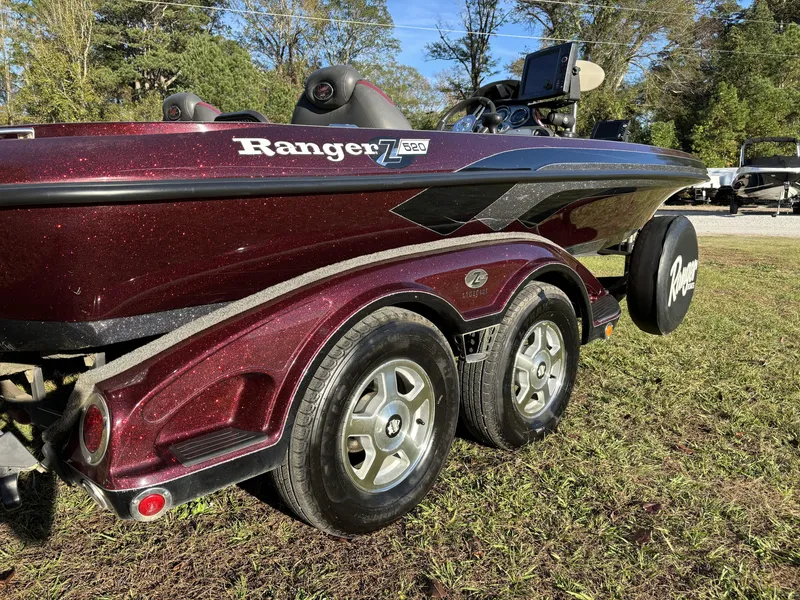 Slide: The Image of 2009 Ranger Z520 Comanche boat with dual axle trailer on grass. - 12