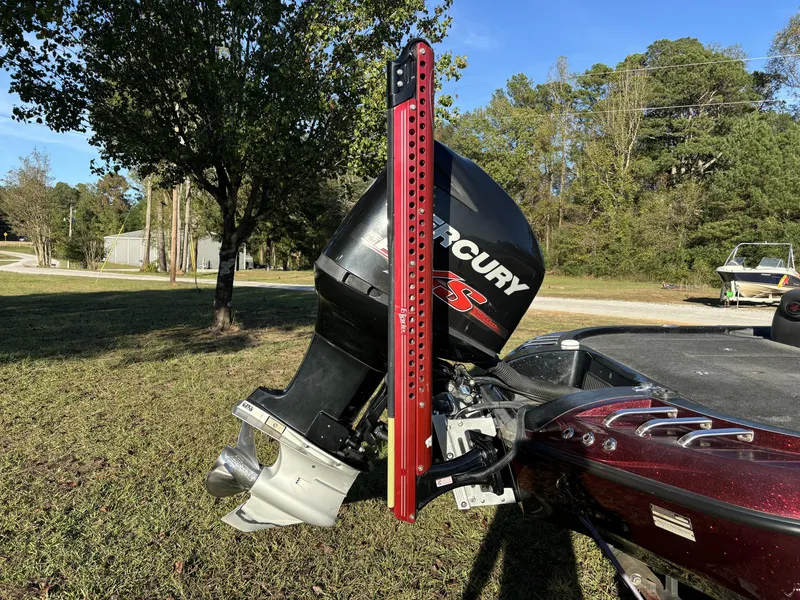 Slide: The Image of 2009 Ranger Z520 Comanche boat with Mercury engine, parked on grass. - 13