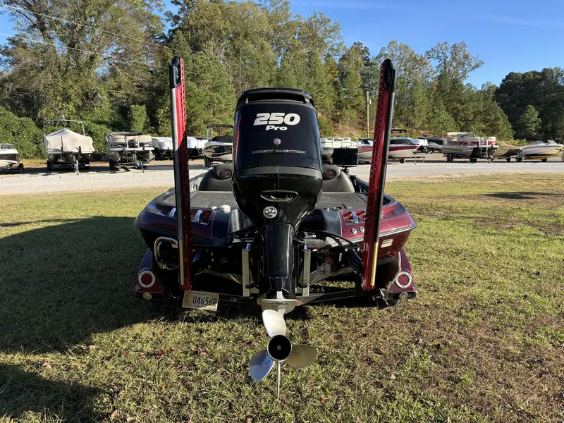 Slide: The Image of 2009 Ranger Z520 Comanche boat with 250 Pro motor, parked on grass. - 8