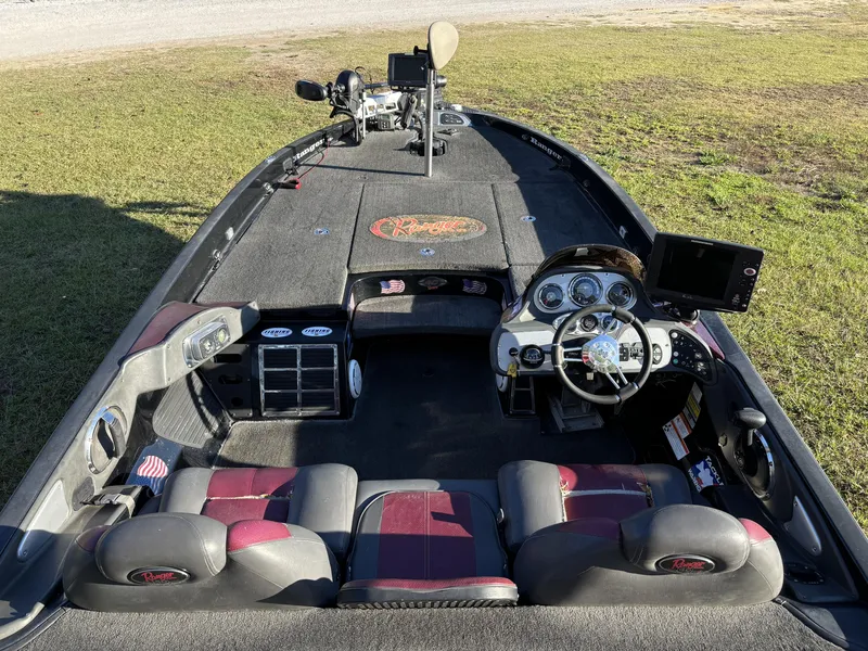 Slide: The Image of 2009 Ranger Z520 Comanche boat interior with steering wheel and dashboard, parked on grass. - 9