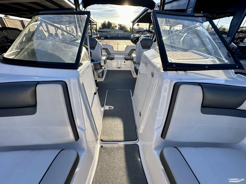 Slide: The Image of 2019 Yamaha AR240 boat interior with seating and windshield, under a sunny sky. - 6