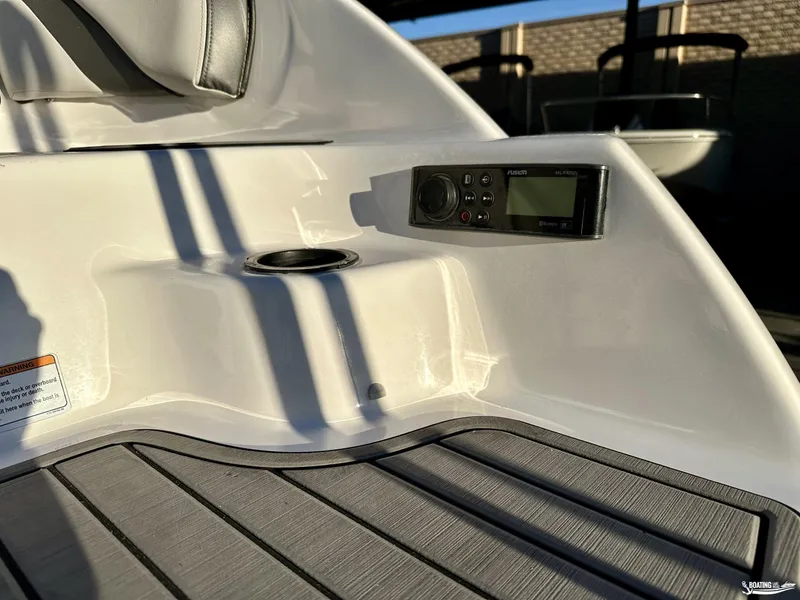 Slide: The Image of 2019 Yamaha AR240 boat interior with Fusion stereo system and cup holder. - 7