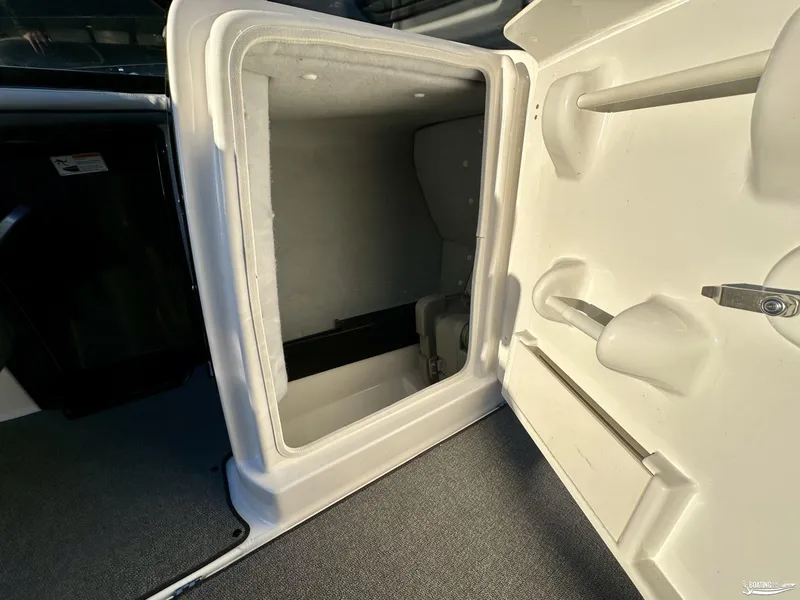 Slide: The Image of 2019 Yamaha AR240 boat interior storage compartment, open door view. - 8
