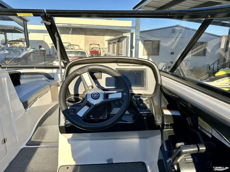 Slide: The Image of 2019 Yamaha AR240 boat cockpit with steering wheel and dashboard controls. - 9
