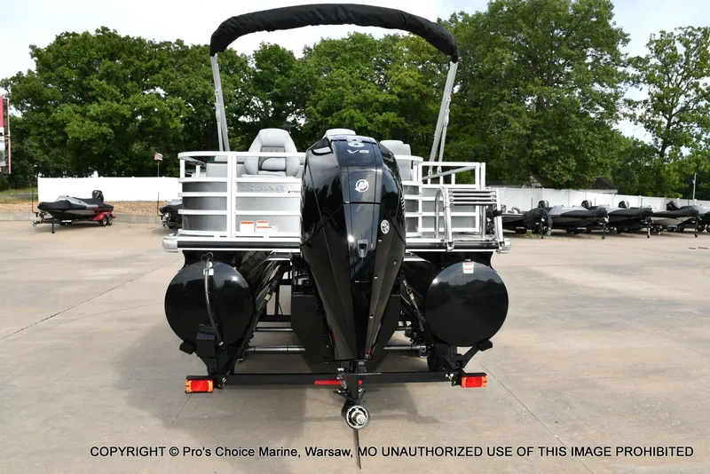 Slide: The Image of 2025 Ranger 223FC boat with 200HP Mercury 4 Stroke engine, parked outdoors. - 15