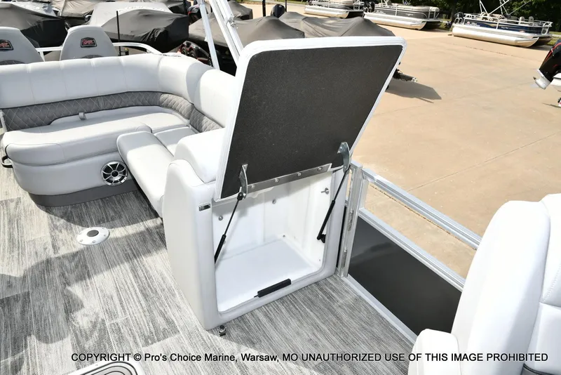 Slide: The Image of 2025 Ranger 223FC boat interior with open storage compartment and seating. - 26
