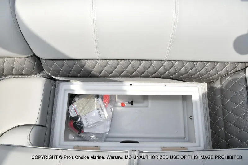 Slide: The Image of Storage compartment in 2025 Ranger 223FC boat with quilted upholstery. - 28