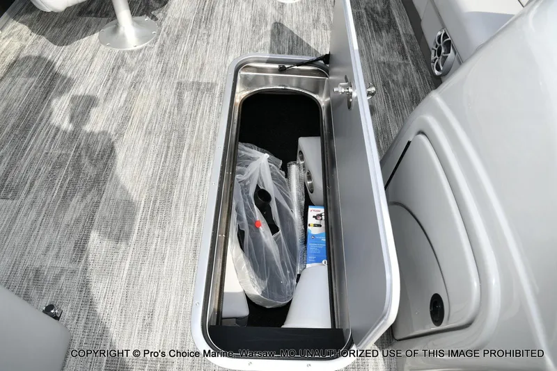 Slide: The Image of Storage compartment in 2025 Ranger 223FC boat with gray flooring. - 31