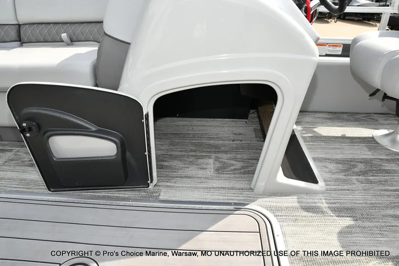 Slide: The Image of 2025 Ranger 223FC boat interior with open storage compartment and seating. - 32