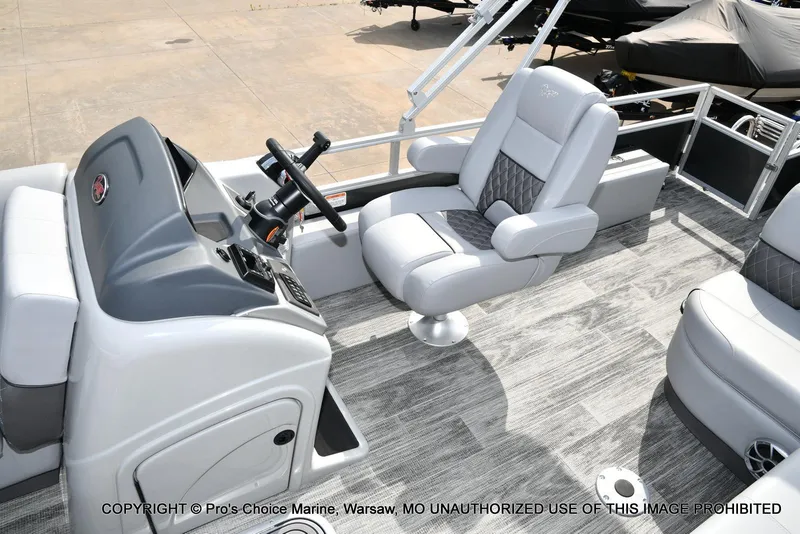 Slide: The Image of 2025 Ranger 223FC boat interior with steering console and plush seating. - 34