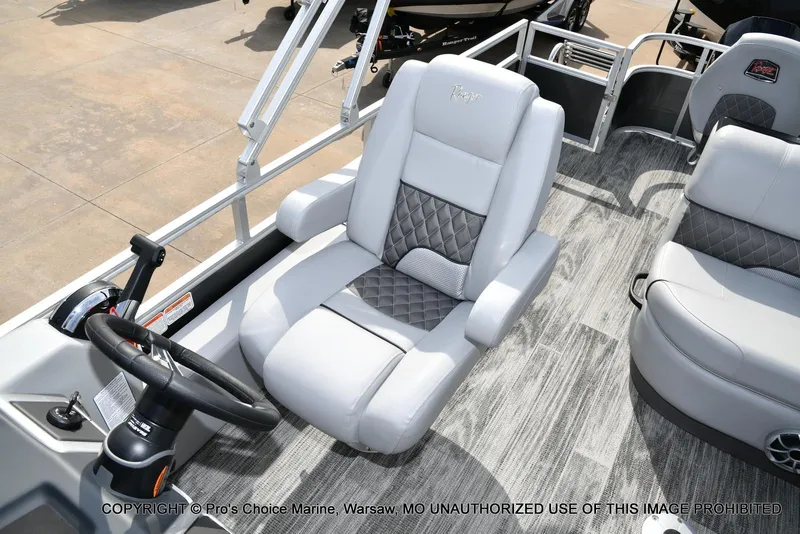 Slide: The Image of 2025 Ranger 223FC boat interior with luxurious seating and modern steering console. - 35