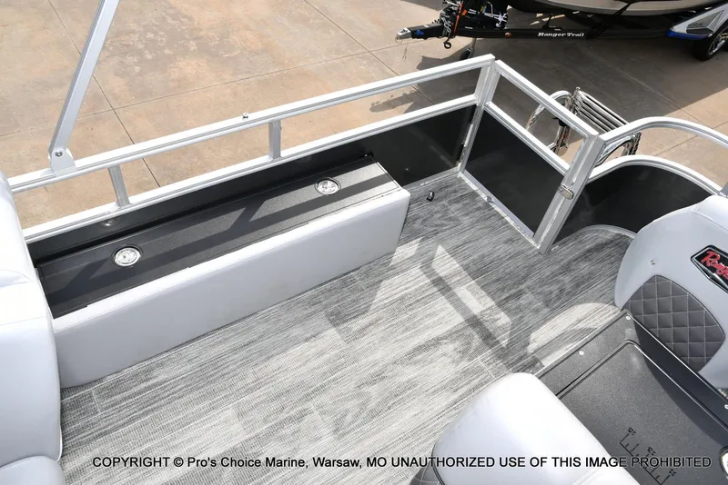 Slide: The Image of 2025 Ranger 223FC boat interior with gray flooring and seating, featuring a 200HP Mercury engine. - 43