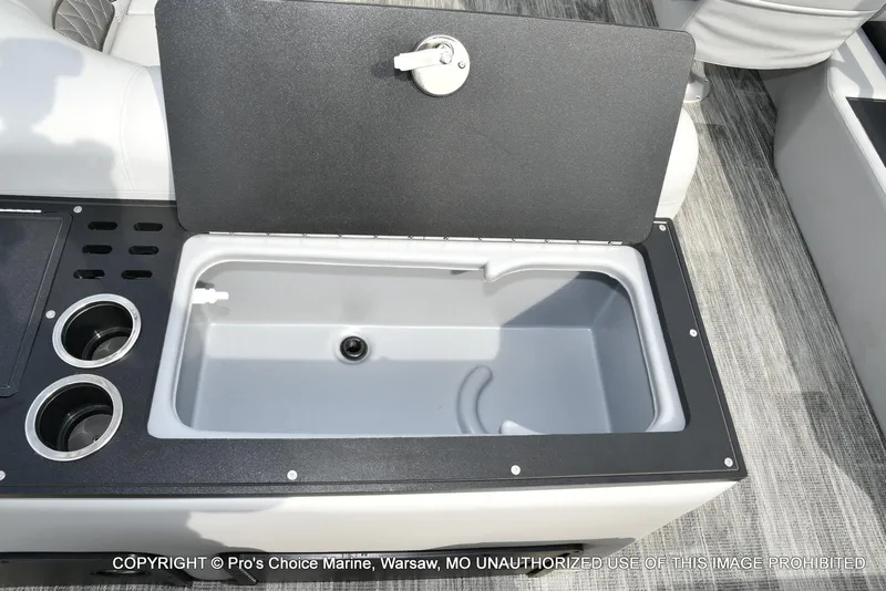 Slide: The Image of Ranger 223FC boat interior with open storage compartment and cup holders, 2025 model. - 48