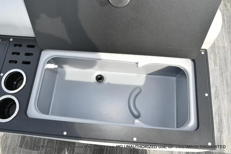 Slide: The Image of 2025 Ranger 223FC boat interior with storage compartment and cup holders. - 49