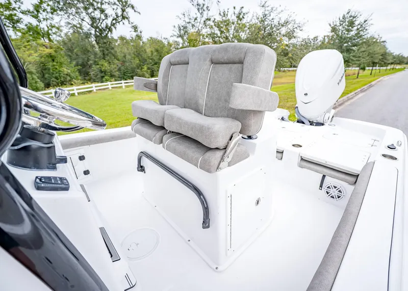 Slide: The Image of 2025 Sea Hunt BX 25 FS boat interior with cushioned seating and steering console. - 16