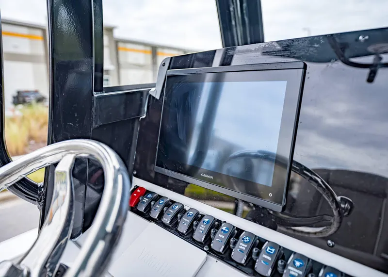 Slide: The Image of 2025 Sea Hunt BX 25 FS boat dashboard with Garmin display and control panel. - 22