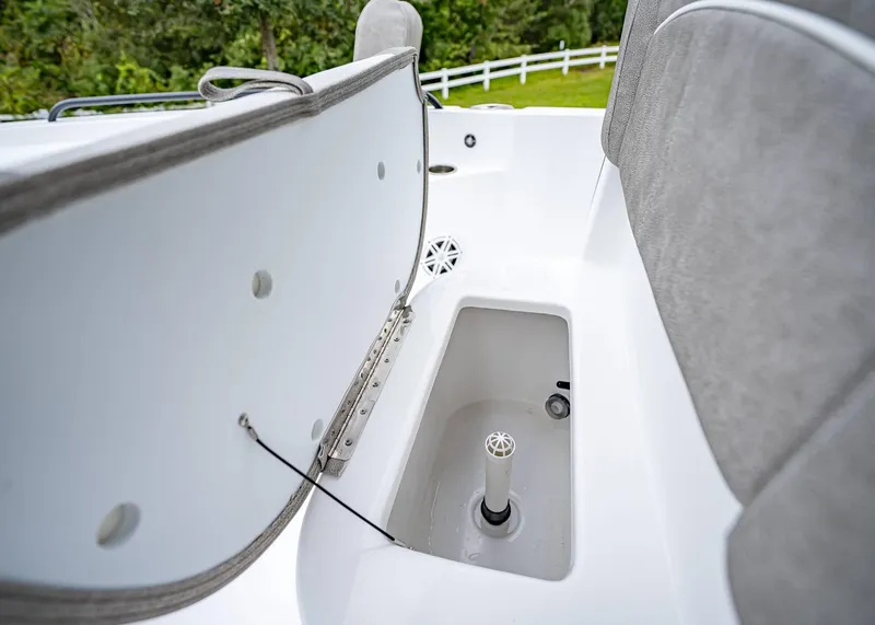 Slide: The Image of 2025 Sea Hunt BX 25 FS boat storage compartment with open lid, showcasing interior features. - 30