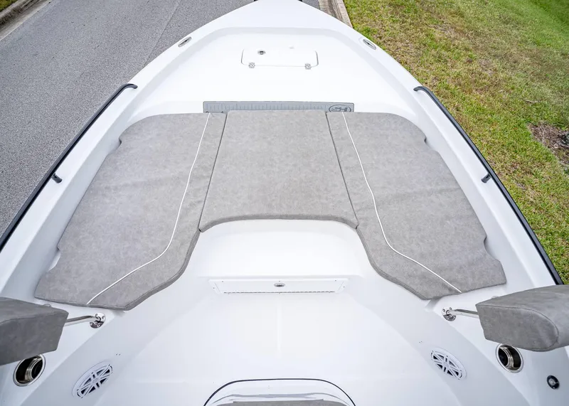 Slide: The Image of 2025 Sea Hunt BX 25 FS boat deck with cushioned seating and storage compartments. - 36