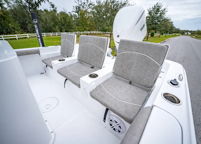Slide: The Image of 2025 Sea Hunt BX 25 FS boat interior with gray cushioned seats and cup holders. - 6