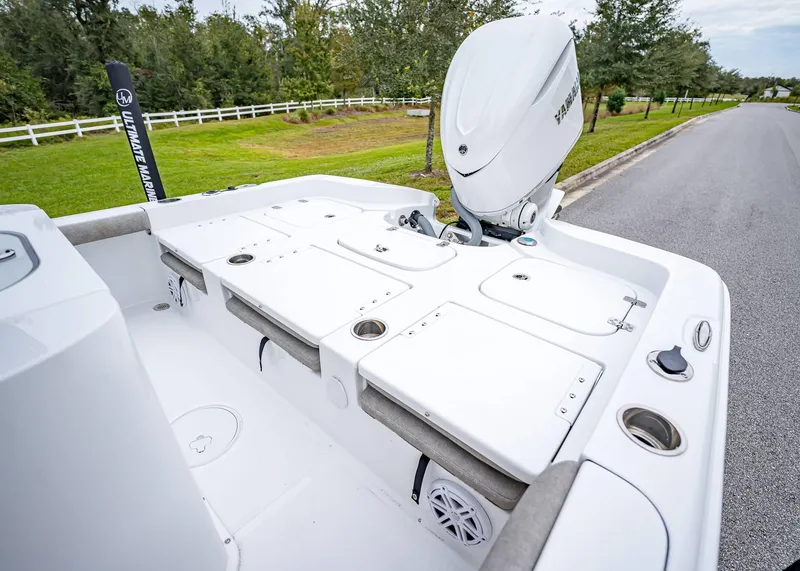 Slide: The Image of 2025 Sea Hunt BX 25 FS boat deck with Yamaha outboard motor, parked on a road. - 7