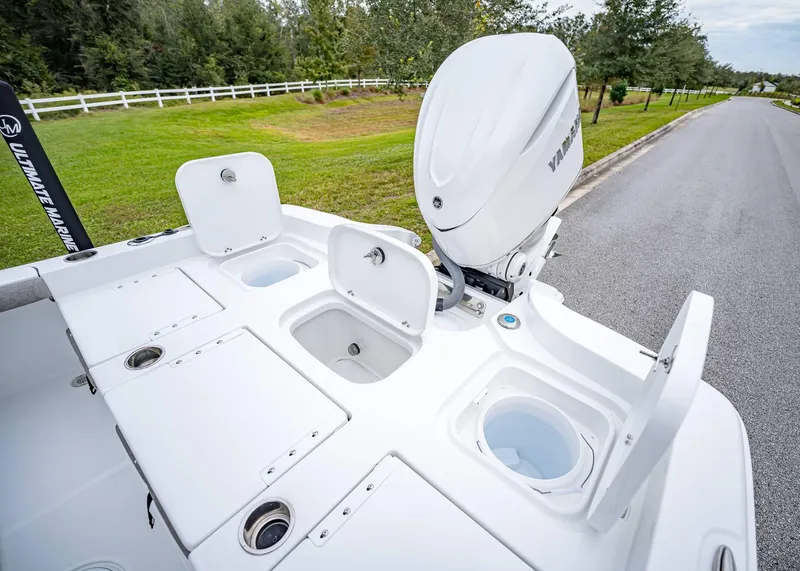 Slide: The Image of 2025 Sea Hunt BX 25 FS boat with open storage compartments and Yamaha outboard motor. - 9