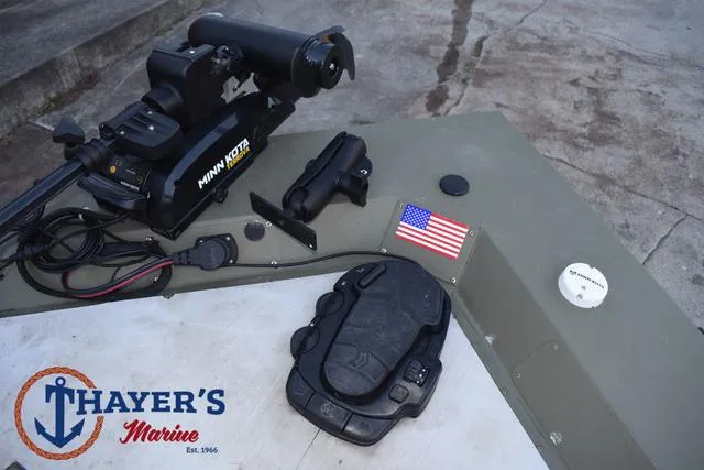 Slide: The Image of 2023 Tracker GRIZZLY® 1648 SC boat with Minn Kota motor and Thayer's Marine logo. - 12