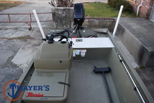 Slide: The Image of 2023 Tracker GRIZZLY® 1648 SC boat interior with motor, Thayer's Marine logo visible. - 15