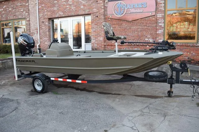 Slide: The Image of 2023 Tracker GRIZZLY® 1648 SC boat on trailer, parked outside brick building. - 32
