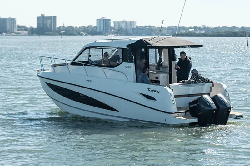 Slide: The Image of 2024 Bayliner Trophy T29EX boat cruising on a sunny day. - 3