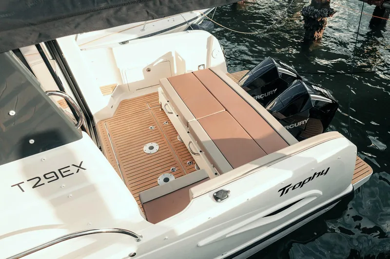 Slide: The Image of 2024 Bayliner Trophy T29EX boat with dual Mercury engines, featuring spacious deck seating. - 4