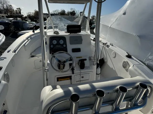 Slide: The Image of 2013 Tidewater 230 CC Adventure boat cockpit with steering wheel and control panel. - 5