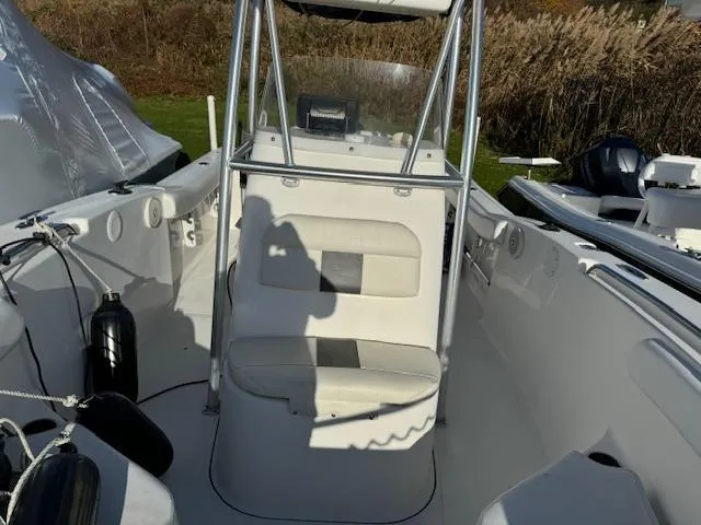 Slide: The Image of 2013 Tidewater 230 CC Adventure boat interior with seating and console. - 7