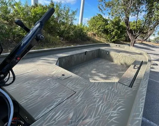 Slide: The Image of 2025 Tracker Grizzly 1654 T Sportsman boat with camouflage design in a natural setting. - 3