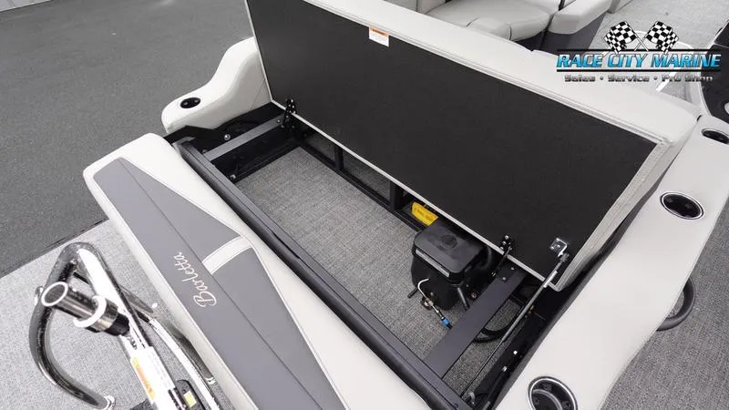 Slide: The Image of 2025 Barletta C22U boat interior storage compartment with open seat and visible battery. - 16