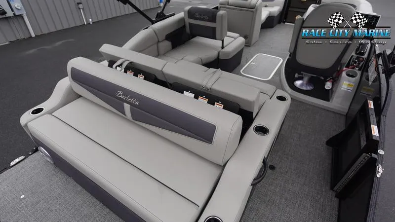Slide: The Image of 2025 Barletta C22U pontoon boat interior with gray seating and Race City Marine logo. - 20