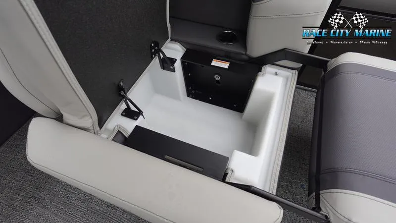 Slide: The Image of 2025 Barletta C22U boat storage compartment with cushioned seating and Race City Marine branding. - 24