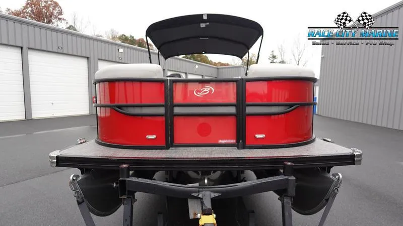 Slide: The Image of 2025 Barletta C22U pontoon boat, red exterior, parked at Race City Marine. - 3