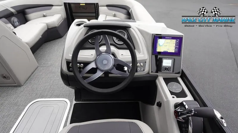 Slide: The Image of 2025 Barletta C22U boat dashboard with steering wheel and navigation display. - 42