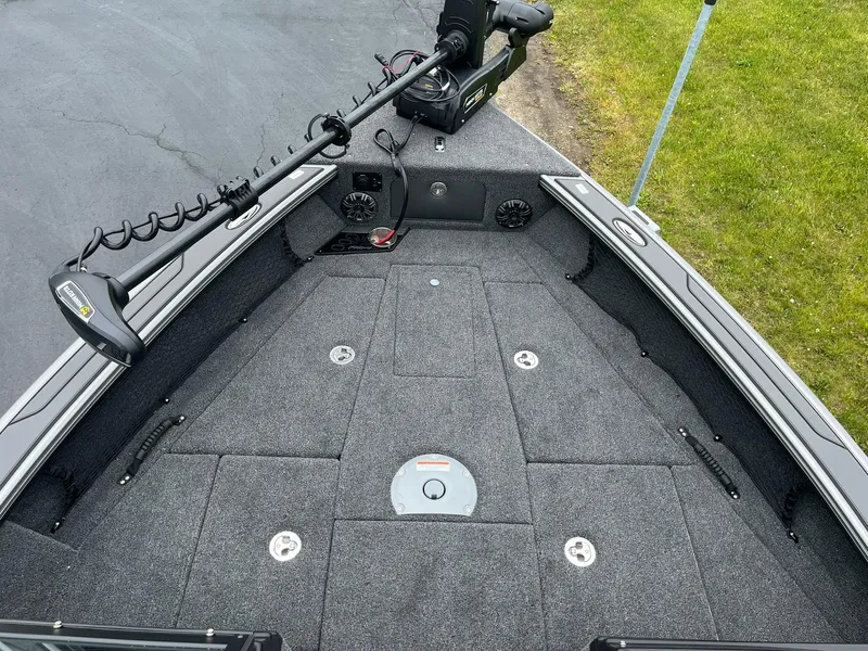 Slide: The Image of 2025 Lund 1975 Pro-V boat deck with trolling motor and storage compartments. - 16