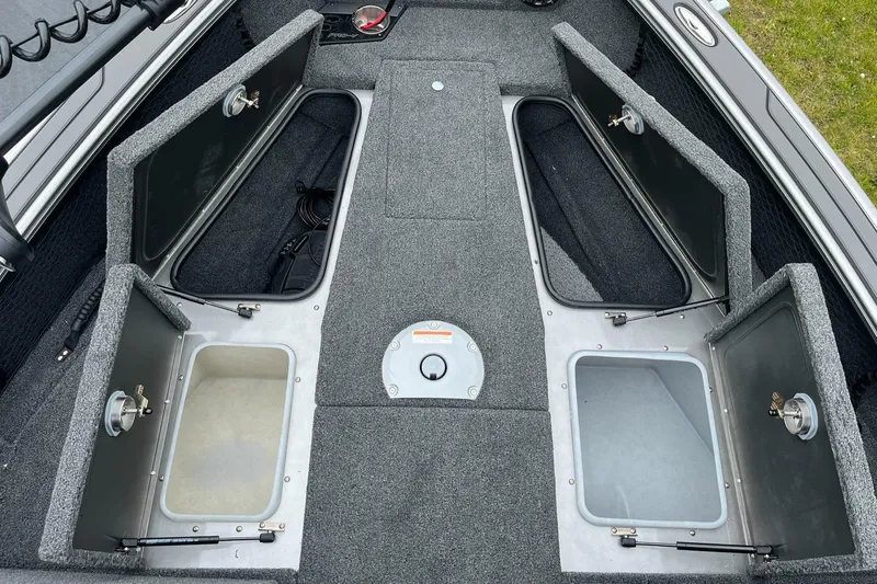 Slide: The Image of 2025 Lund 1975 Pro-V boat storage compartments with open hatches, showcasing spacious interior design. - 17