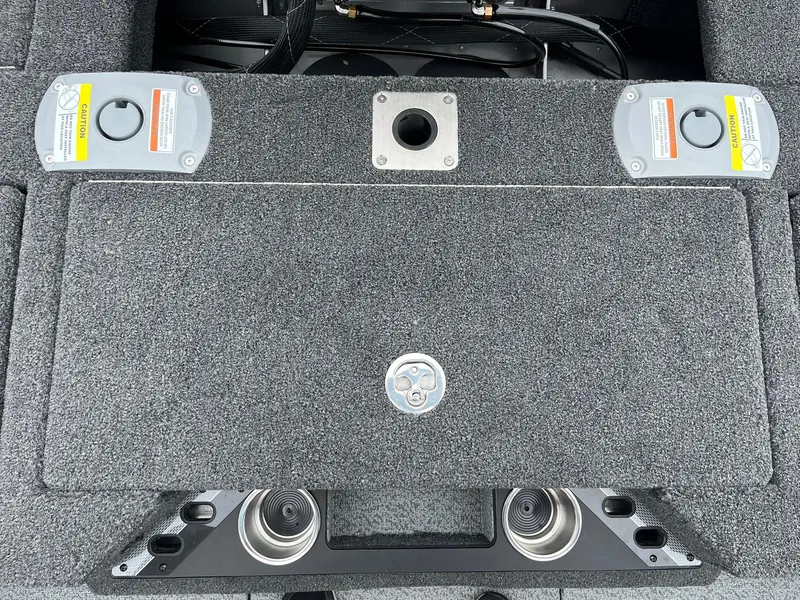 Slide: The Image of Interior view of 2025 Lund 1975 Pro-V boat, featuring storage compartments and cup holders. - 20