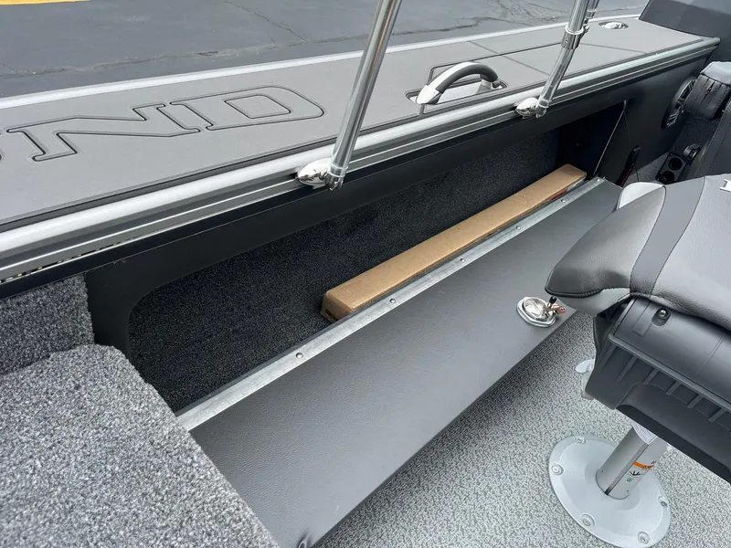 Slide: The Image of 2025 Lund 1975 Pro-V boat interior with storage compartment and seating. - 25