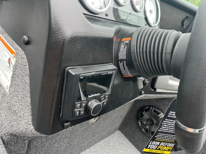 Slide: The Image of Control panel of 2025 Lund 1975 Pro-V boat with gauges and stereo system. - 29