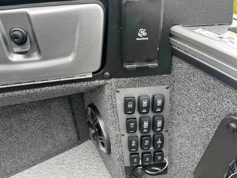 Slide: The Image of Control panel of 2025 Lund 1975 Pro-V boat with switches and speaker. - 30