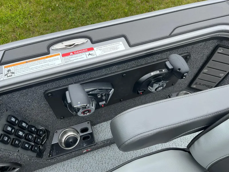 Slide: The Image of Control panel of 2025 Lund 1975 Pro-V boat with throttle and switches. - 31