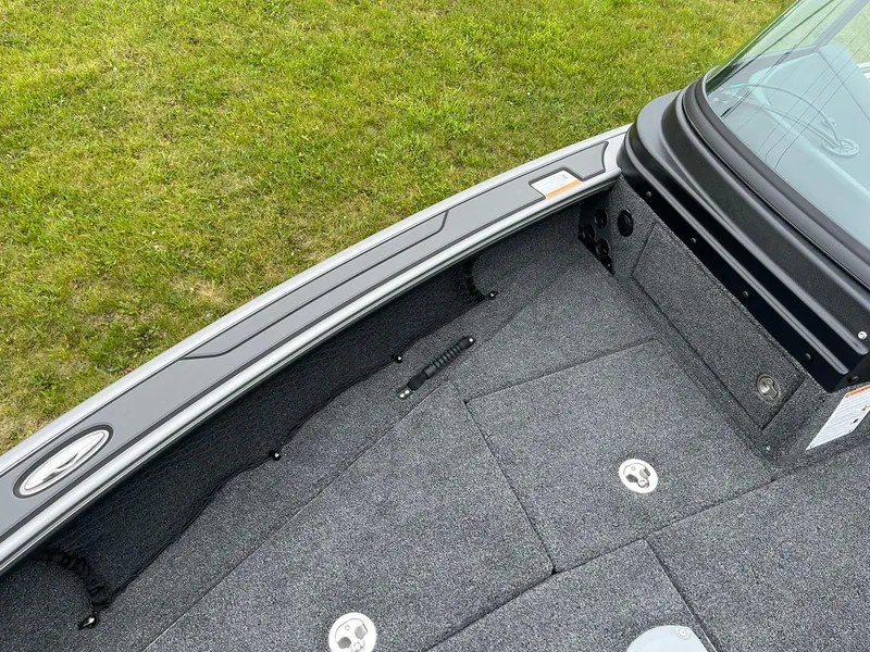 Slide: The Image of 2025 Lund 1975 Pro-V boat interior with gray carpet and sleek design. - 34