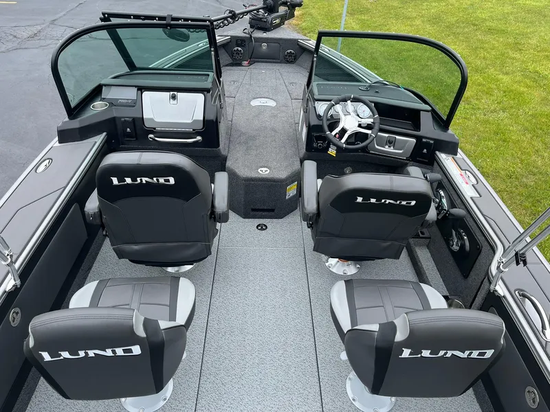 Slide: The Image of 2025 Lund 1975 Pro-V boat interior with four seats and steering console. - 6