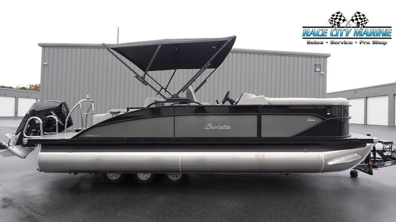 The Image of 2025 Barletta C22UC pontoon boat with canopy at Race City Marine dealership. - 1